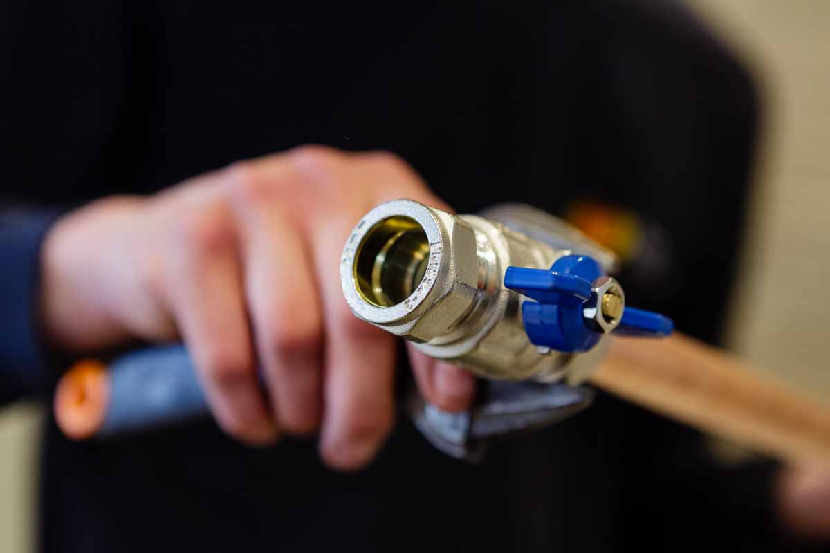 A plumber tightening a pipe joint