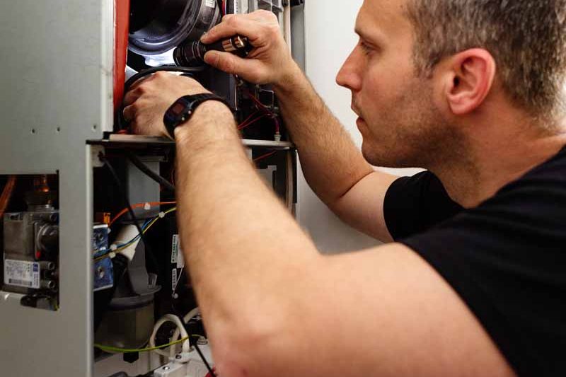 Inspecting and servicing a boiler in Winchester